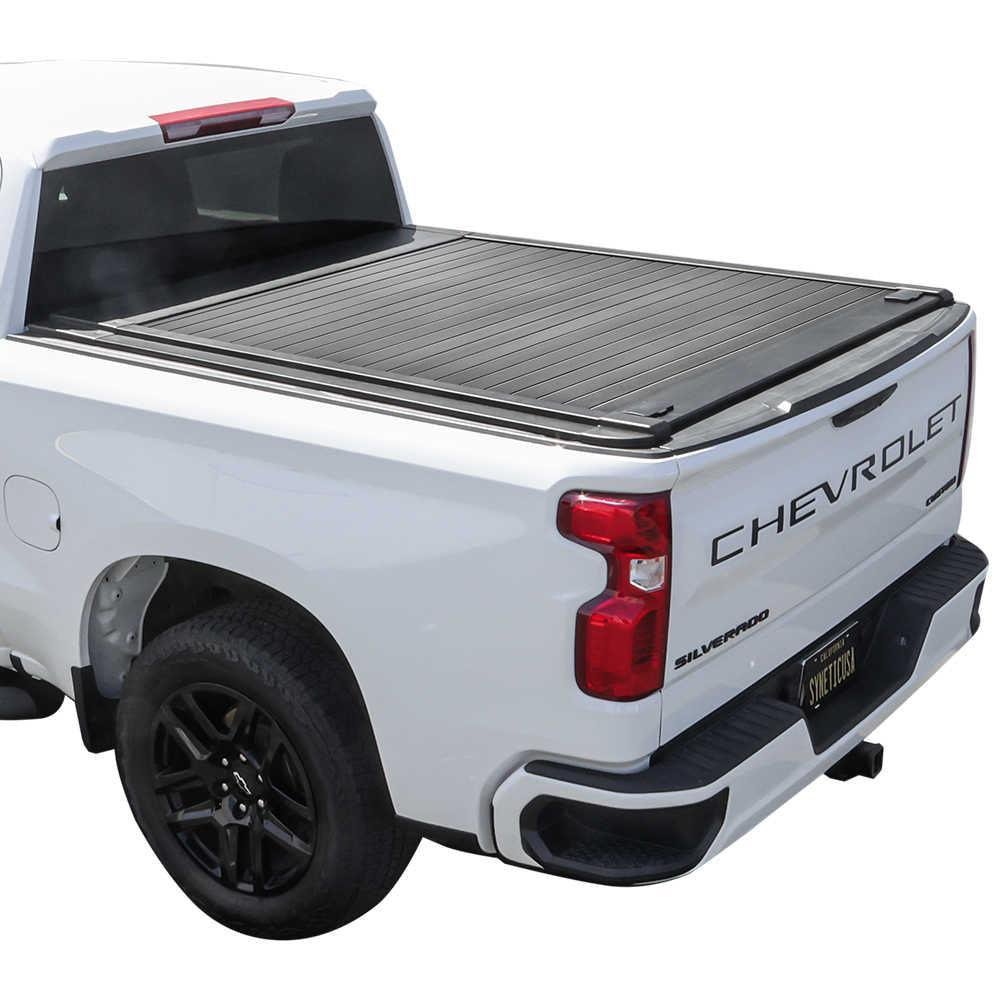 Alaska one-piece hinged tonneau cover open on a GMC Sierra 1500 in winter