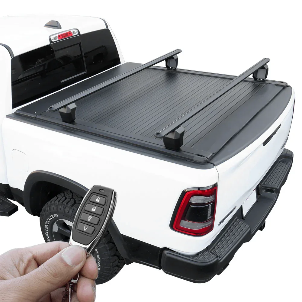 Alaska one-piece hinged tonneau cover open on a Ram 1500 in winter